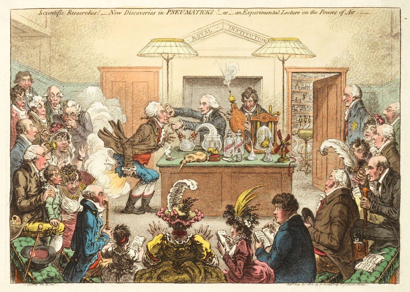 A crowded Royal Institution audience watches a lecturer hold a man’s nose while an assistant works bellows and gas erupts behind him; scientific instruments cover the demonstration table.